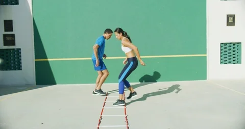 Athletes training on an agility ladder Stock Footage 104012922