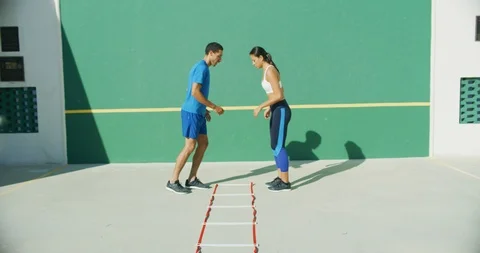 Athletes training on an agility ladder Stock Footage 104013126