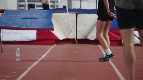 Athletes training for pole vaulting at an indoor arena Stock Footage 318463496