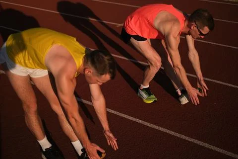 Athletes warming up at the stadium Stock Photos