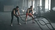 Athletes Working Out With Battle Ropes At Gym. 4K Slow Motion Stock Footage
