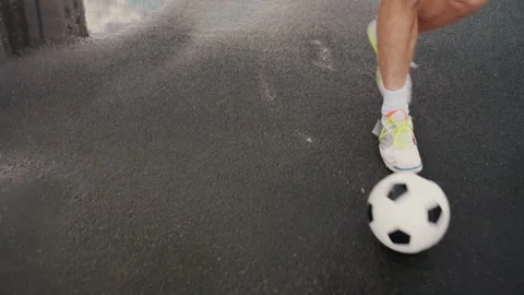 Athletic activity on rainy urban sidewalk with reflections and splashes, Someone Stock Footage 327904939