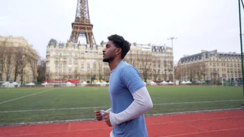 Athletic african american man jogging with eiffel tower view Stock Footage 327456829