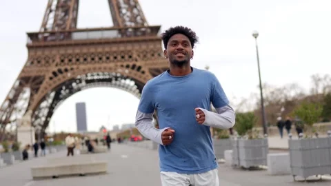 Athletic african american man jogging with eiffel tower in paris Stock Footage 327456852