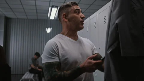 Athletic Airport Security Officer Interacting with Colleagues in Locker Room Stock Footage 334009626