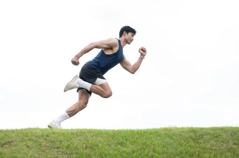 Athletic Asian Man Jumping During Sprint Training Stock Photos