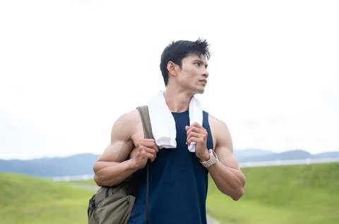 Athletic Asian Man Walking with Backpack After Workout Stock Photos
