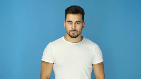 Athletic bearded guy smiling on blue background. Close up Stock Footage 130831548