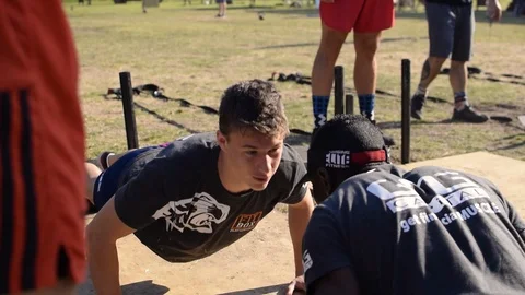 Athletic black &amp; caucasian men doing press ups, push ups at a cross fit Stock Footage 105017014