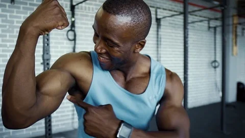 flexing Athletic black man flexing his muscles a... | Stock Video | Pond5