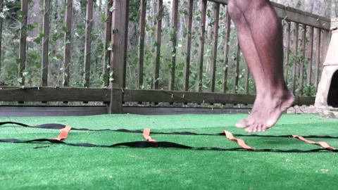 Athletic Black Man Performs Hop Agility Ladder Drill, Turf, Closeup Slow Motion Stock Footage 161425077