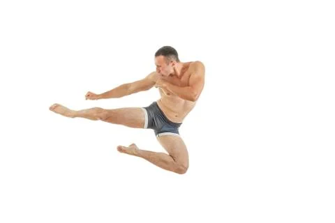 Athletic boxer fighter kicking jumping in the air Stock Photos