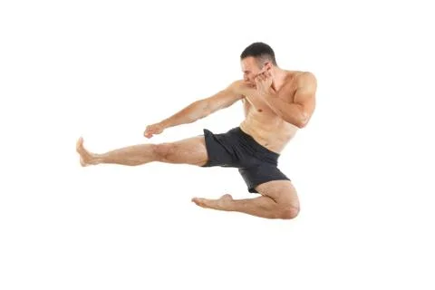 Athletic boxer fighter performing a flying side kick Stock Photos