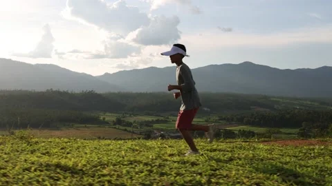 Athletic boy running on mountain trail at sunset, healthy fitness lifestyle, Stock Footage 203805553