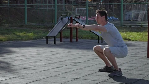Athletic caucasian man doing squats wearing smartwatches. Stock Footage 95231856