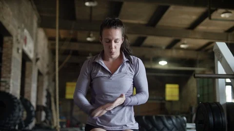 Athletic caucasian woman rests while kneeling in MMA gym Video stock 124504792