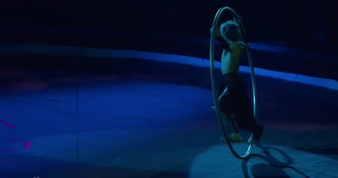 Athletic circus performer is spinning in a massive wheel, gymnastics, 4k Stock Footage 147191545
