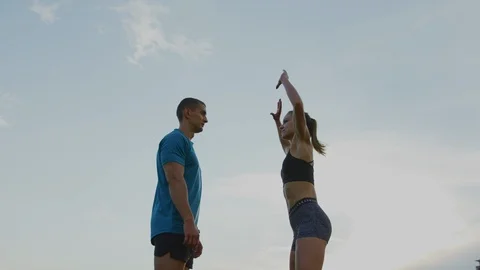 Athletic couple doing jumping jacks Stock Footage 100032199