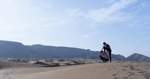 Athletic couple exercising in a desert Stock Footage 107611142