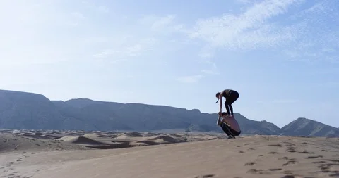 Athletic couple exercising in a desert Stock Footage 107611346