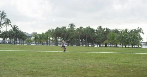 Athletic couple jogging in a park Stock Footage 97052023