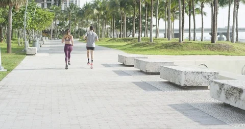 Athletic couple jogging in a park Stock Footage 97253359