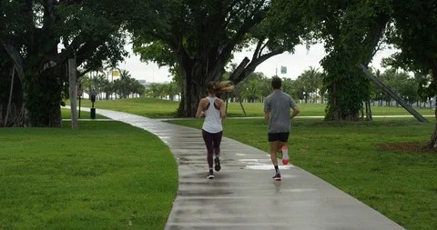 Athletic couple jogging in a park Stock Footage 97253623