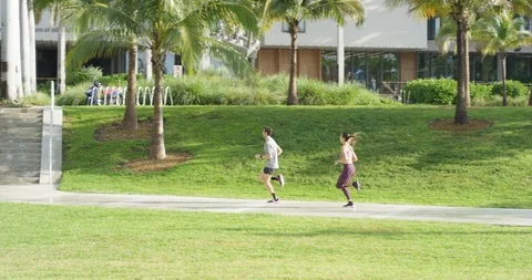 Athletic couple jogging in a park Stock Footage 97253873