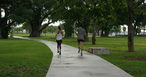 Athletic couple jogging in a park Stock Footage 97254080