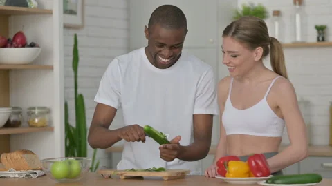 Athletic Couple Peeling Cucumber in Kitchen Stock Footage 154723480