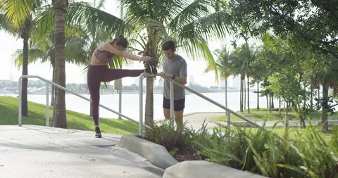 Athletic couple stretching on a staircase Stock Footage 97051280