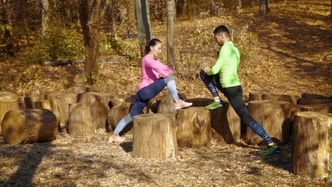 Athletic couple training together outside in autumn forest Stock Footage 118772798