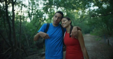 Athletic couple walking through a forrest together Stock Footage 104229901