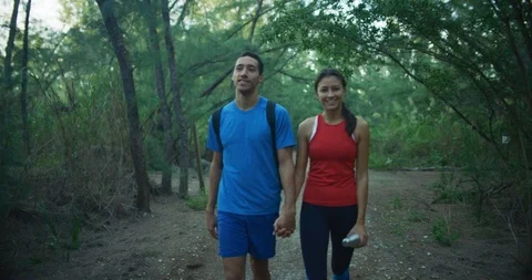 Athletic couple walking through a forrest together Stock Footage 104230106