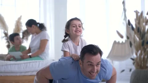 Athletic dad doing push-ups with daughter on back Stock Footage 160938508