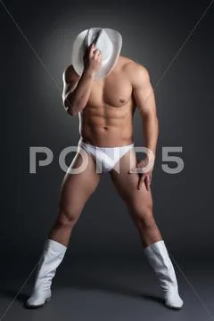 Athletic dancer posing in cowboy hat Stock Photos
