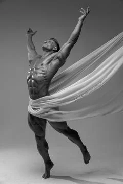 Athletic faceless man posing in a studio with a white cloth in an original way Stock Photos