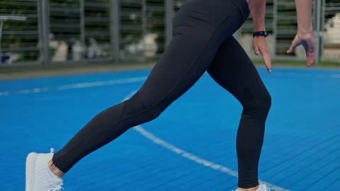 Athletic female doing inverted lunges while training on street stadium Stock Footage 252058093
