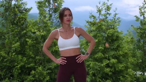 Athletic female doing torso rotation as warmup before training Stock Footage 168259348