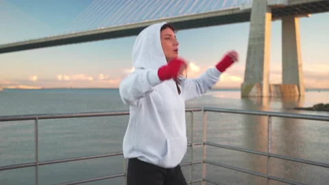 Athletic female prepares for boxing workout outdor Video stock 237160656