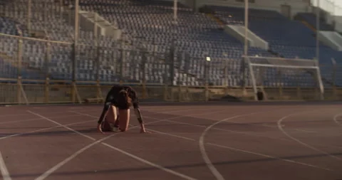 Athletic female sprinter at starting block in stadium Stock Footage 243625189