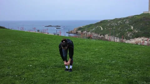 An athletic girl does physical exercises in the fresh air. Stock Footage 189869539