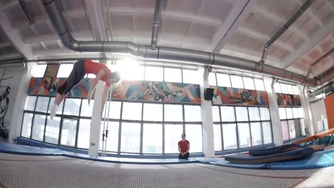 Athletic girl doing backflips in slowmotion Stock Footage 75106502