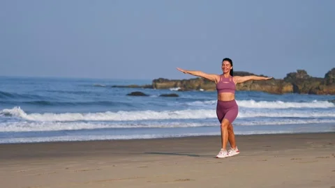 Athletic girl doing exercises on the beach Stock Footage 265877455