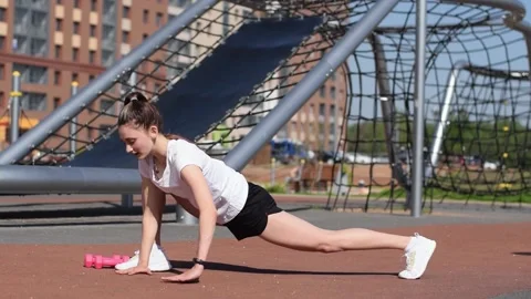 Athletic girl doing a functional workout with a lunge, squat and stretch. Stock Footage 154846352