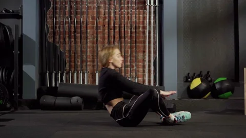Athletic girl doing sit ups in gym Stock Footage 124866838