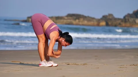 Athletic girl doing warm-up on the ocean shore Stock Footage 265877296