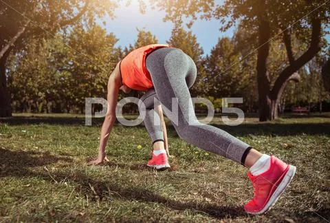 Athletic girl spending her time on outdoors training Stock Photos