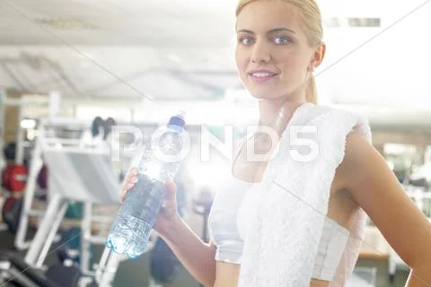 An athletic girl taking break and drinking water Stock Photos