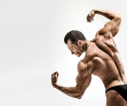 Athletic guy - bodybuilder,  pose on white background Stock Photos